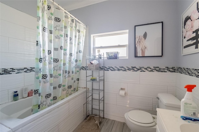 full bathroom with tile walls, vanity, shower / bath combo, and toilet