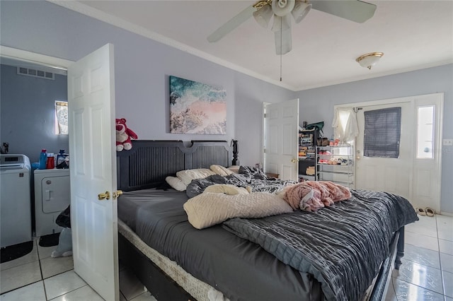 tiled bedroom with ceiling fan, crown molding, and independent washer and dryer