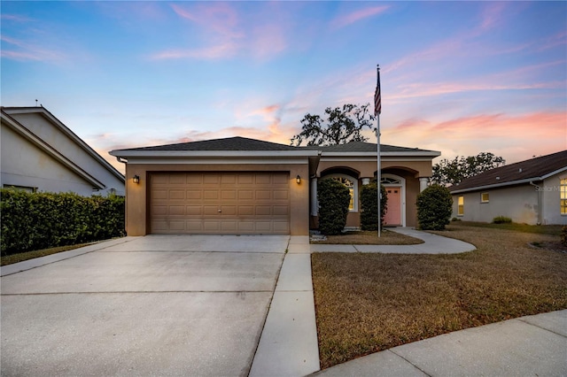 single story home with a yard and a garage