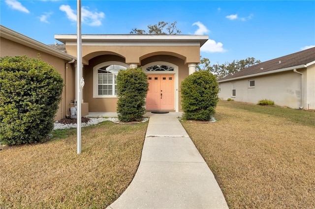 doorway to property with a yard