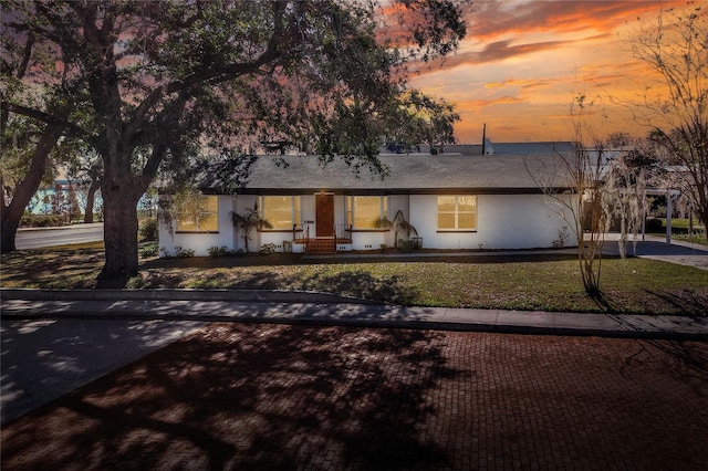 ranch-style house featuring a yard