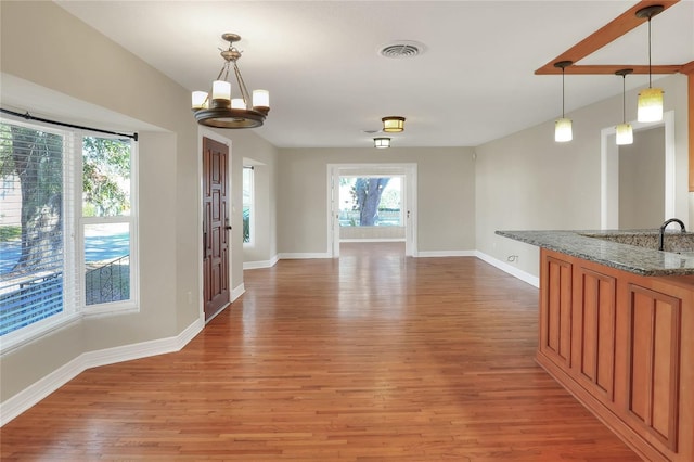 interior space with hardwood / wood-style floors and a notable chandelier