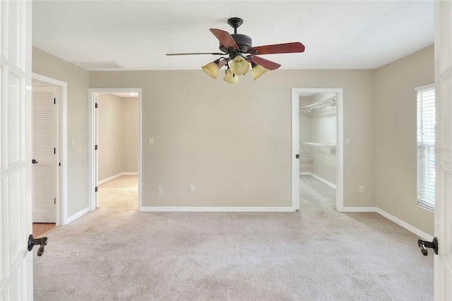 carpeted empty room with ceiling fan