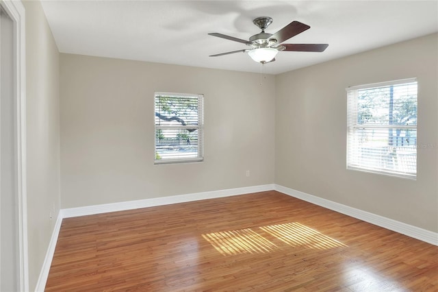 unfurnished room with hardwood / wood-style floors and ceiling fan