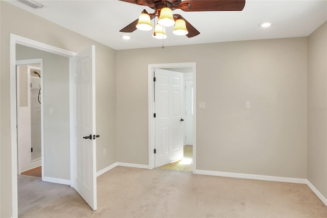 carpeted spare room with ceiling fan