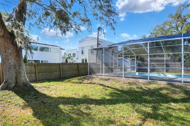 view of yard featuring a lanai and a fenced in pool