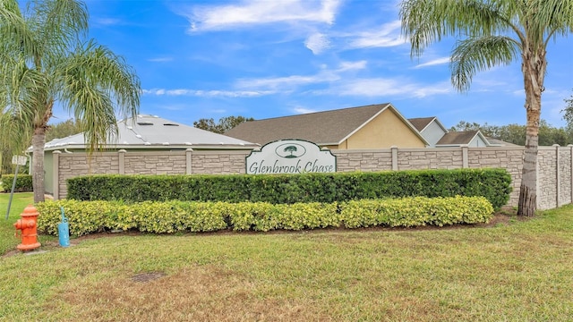 community / neighborhood sign with a lawn