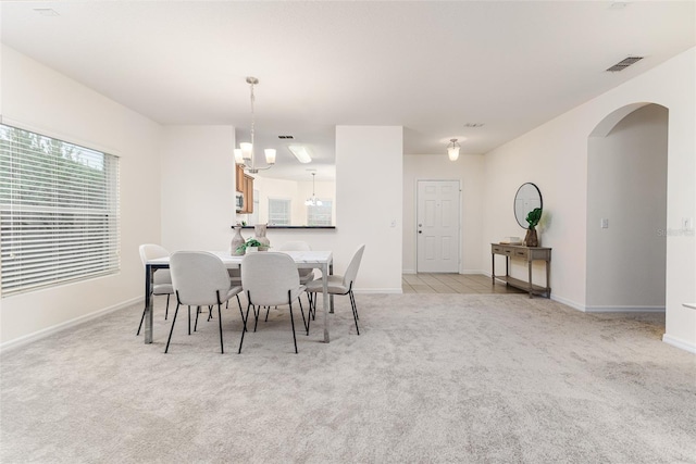 dining space featuring light colored carpet