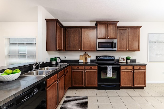 kitchen featuring sink, light tile patterned flooring, and black appliances