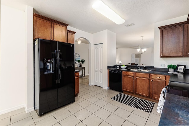 kitchen featuring black appliances, light tile patterned flooring, a textured ceiling, and sink