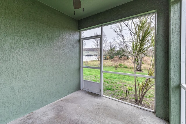 unfurnished sunroom with plenty of natural light and ceiling fan