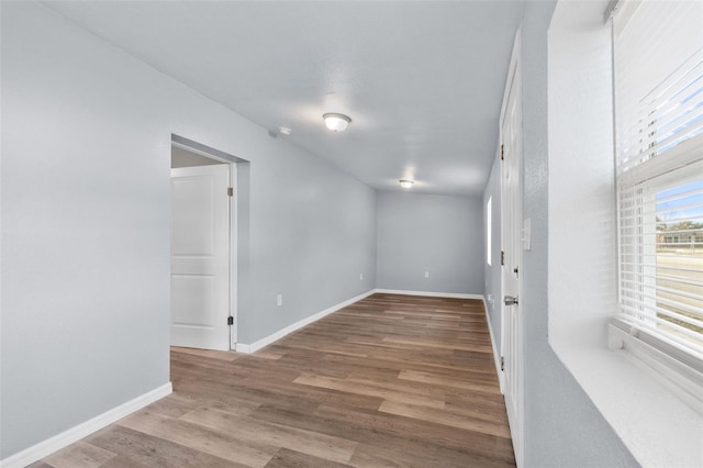 unfurnished room with wood-type flooring