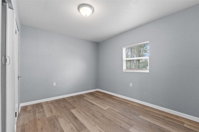 empty room with light hardwood / wood-style flooring