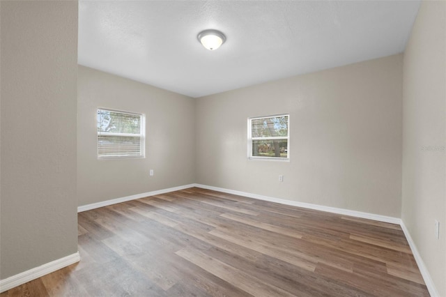 spare room with hardwood / wood-style floors and a textured ceiling