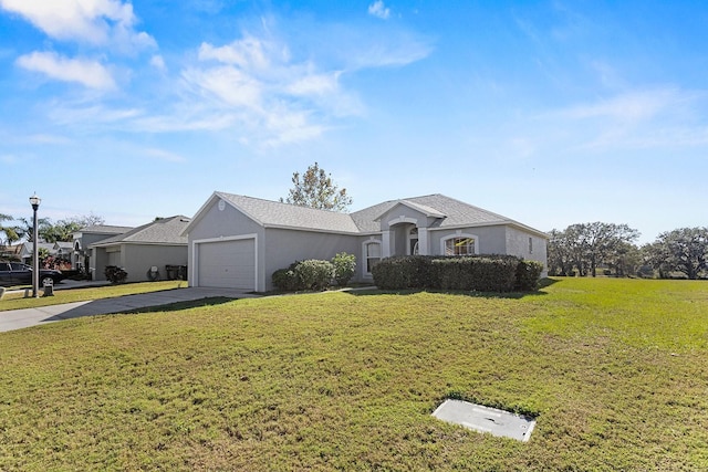 ranch-style house featuring a garage and a front lawn