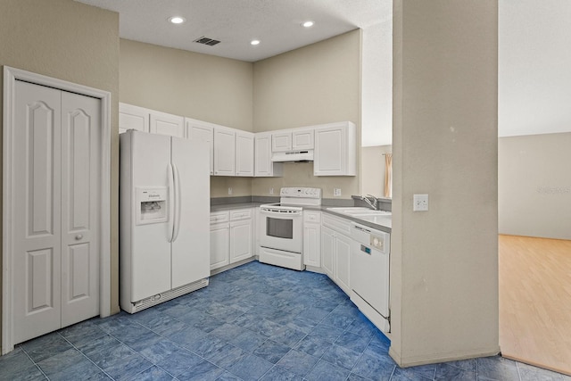 kitchen with white cabinets, white appliances, and sink