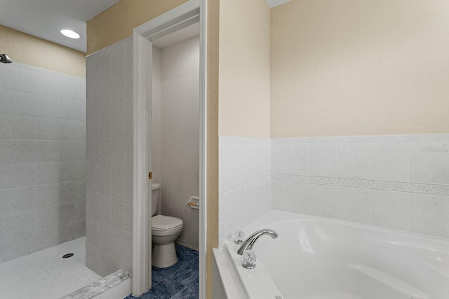 bathroom featuring shower with separate bathtub and toilet