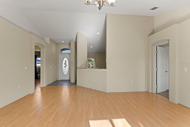 foyer entrance with light hardwood / wood-style flooring and a notable chandelier