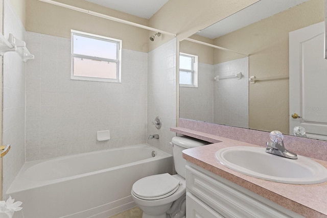 full bathroom with vanity, toilet, and tiled shower / bath