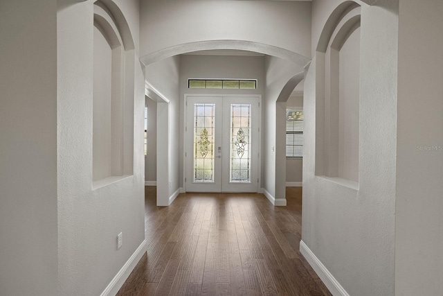 entryway featuring french doors, a high ceiling, and dark hardwood / wood-style floors