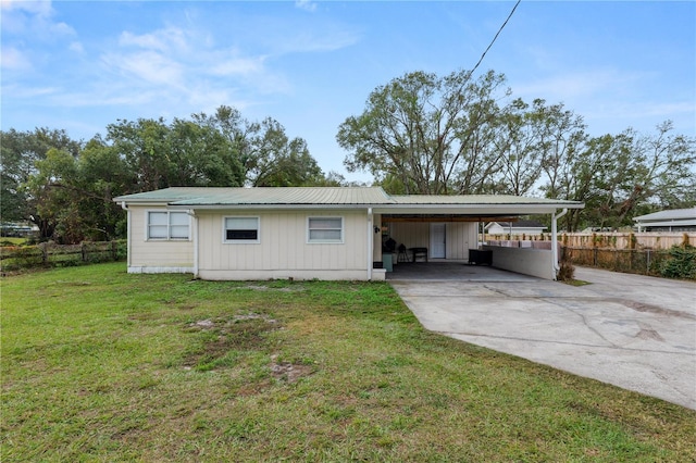210 Wilder Rd, Lakeland, FL 33809 - back of house featuring a carport and a yard