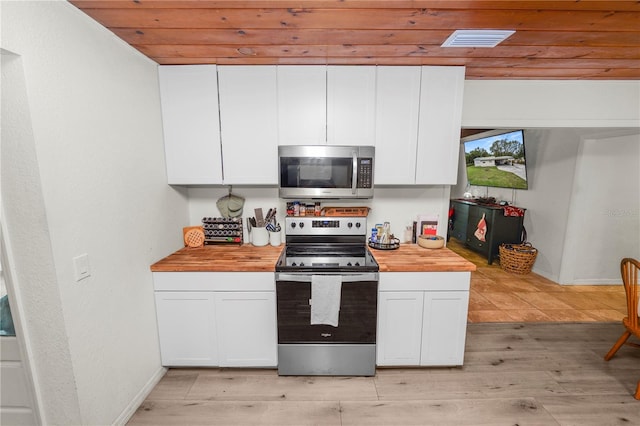 210 Wilder Rd, Lakeland, FL 33809 - kitchen featuring wood counters, white cabinetry, appliances with stainless steel finishes, and light hardwood / wood-style flooring