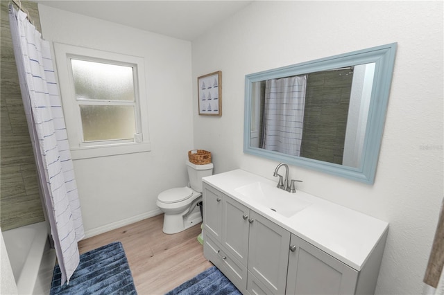 210 Wilder Rd, Lakeland, FL 33809 - full bathroom featuring shower / tub combo with curtain, vanity, wood-type flooring, and toilet