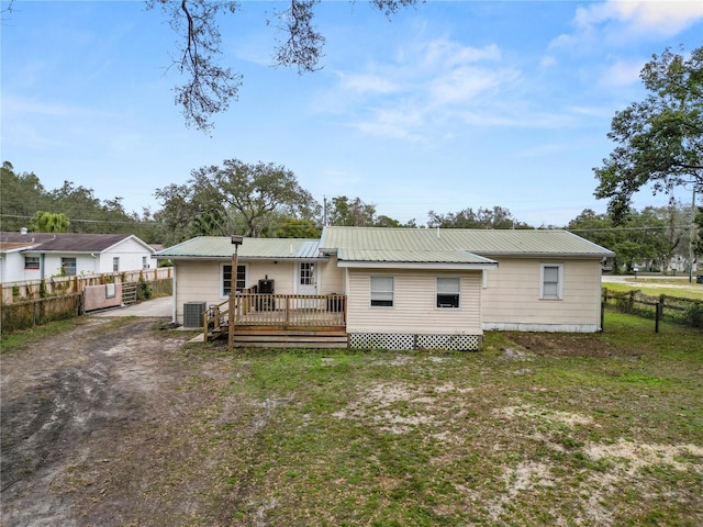 210 Wilder Rd, Lakeland, FL 33809 - rear view of property featuring a yard, central AC, and a deck