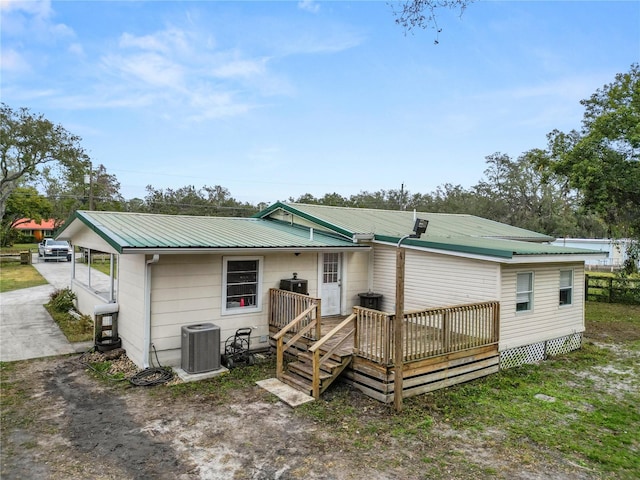 210 Wilder Rd, Lakeland, FL 33809 - rear view of property with a deck and central AC
