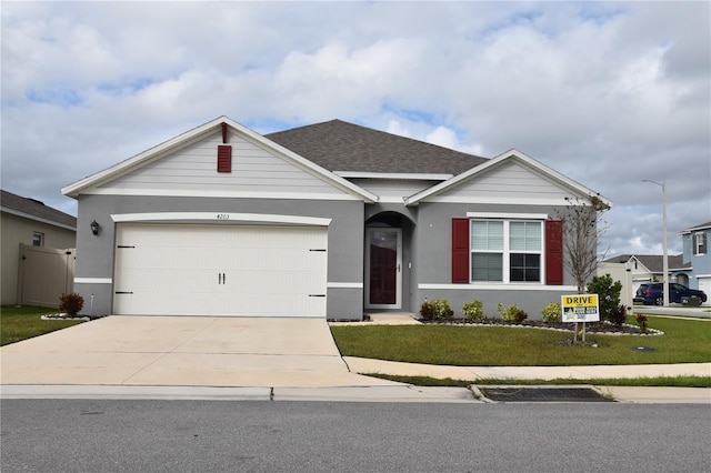 view of front of home featuring a garage and a front lawn