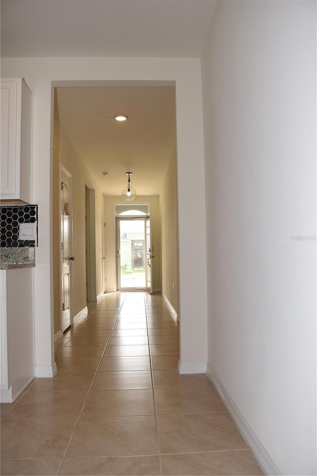 hall with light tile patterned flooring