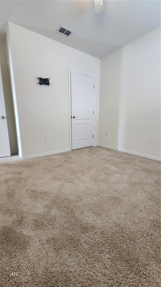 unfurnished room featuring carpet