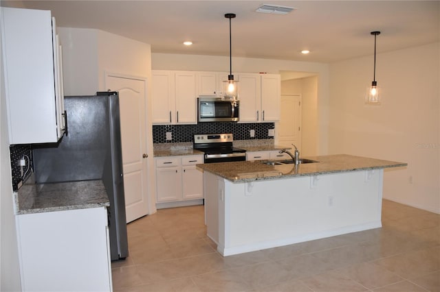 kitchen with white cabinets, decorative light fixtures, sink, and appliances with stainless steel finishes