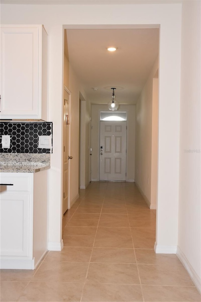 hallway with light tile patterned floors