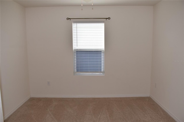 unfurnished room featuring light colored carpet