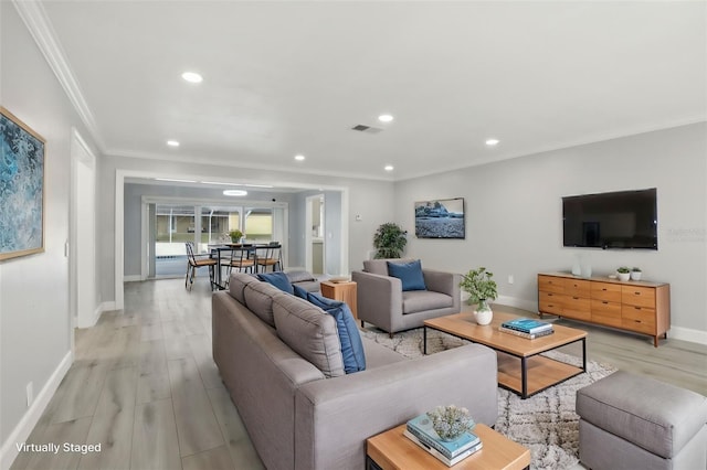 living room featuring crown molding and light hardwood / wood-style flooring