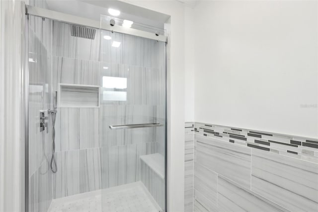 bathroom with a shower with door