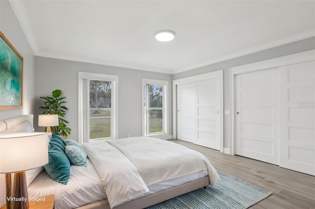 bedroom with hardwood / wood-style flooring and crown molding