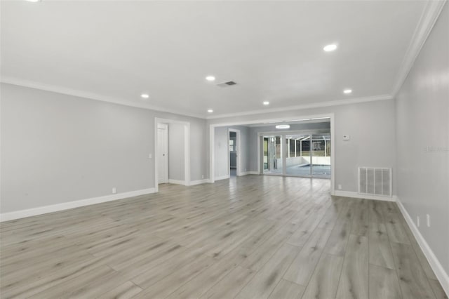 empty room with light wood-type flooring and ornamental molding