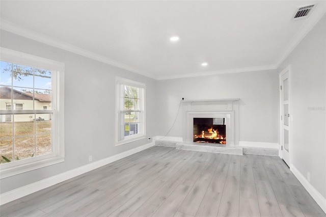 unfurnished living room featuring light wood-type flooring and crown molding