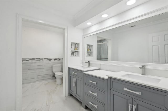 bathroom with vanity, toilet, tile walls, and crown molding