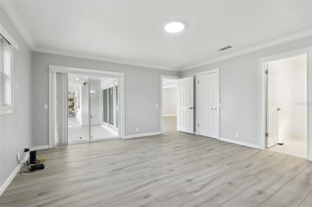 interior space featuring access to exterior, crown molding, and light hardwood / wood-style flooring