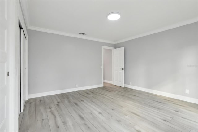 unfurnished bedroom with light hardwood / wood-style flooring, a closet, and ornamental molding