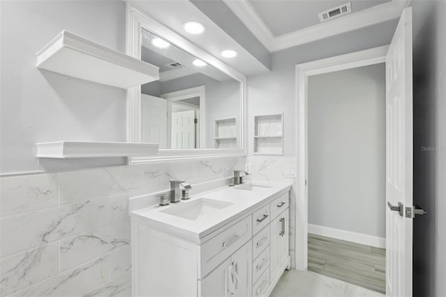 bathroom featuring decorative backsplash, vanity, and ornamental molding