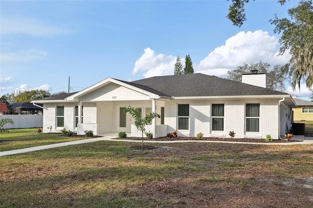 ranch-style house featuring central AC unit and a front lawn