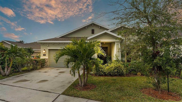 view of front of home with a lawn and a garage