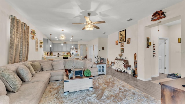 living room with hardwood / wood-style floors and ceiling fan