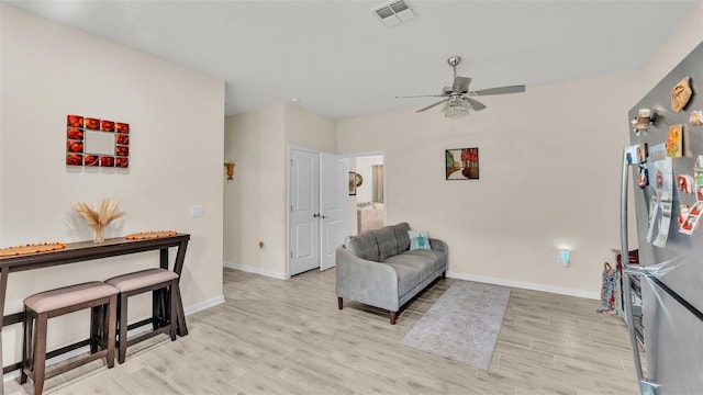 sitting room with light hardwood / wood-style flooring and ceiling fan