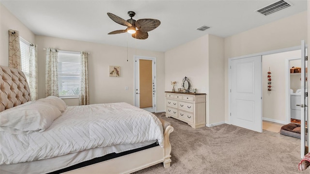 bedroom with ceiling fan, light colored carpet, and washer / clothes dryer