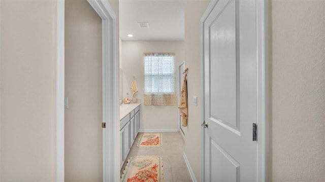 bathroom featuring tile patterned flooring and vanity